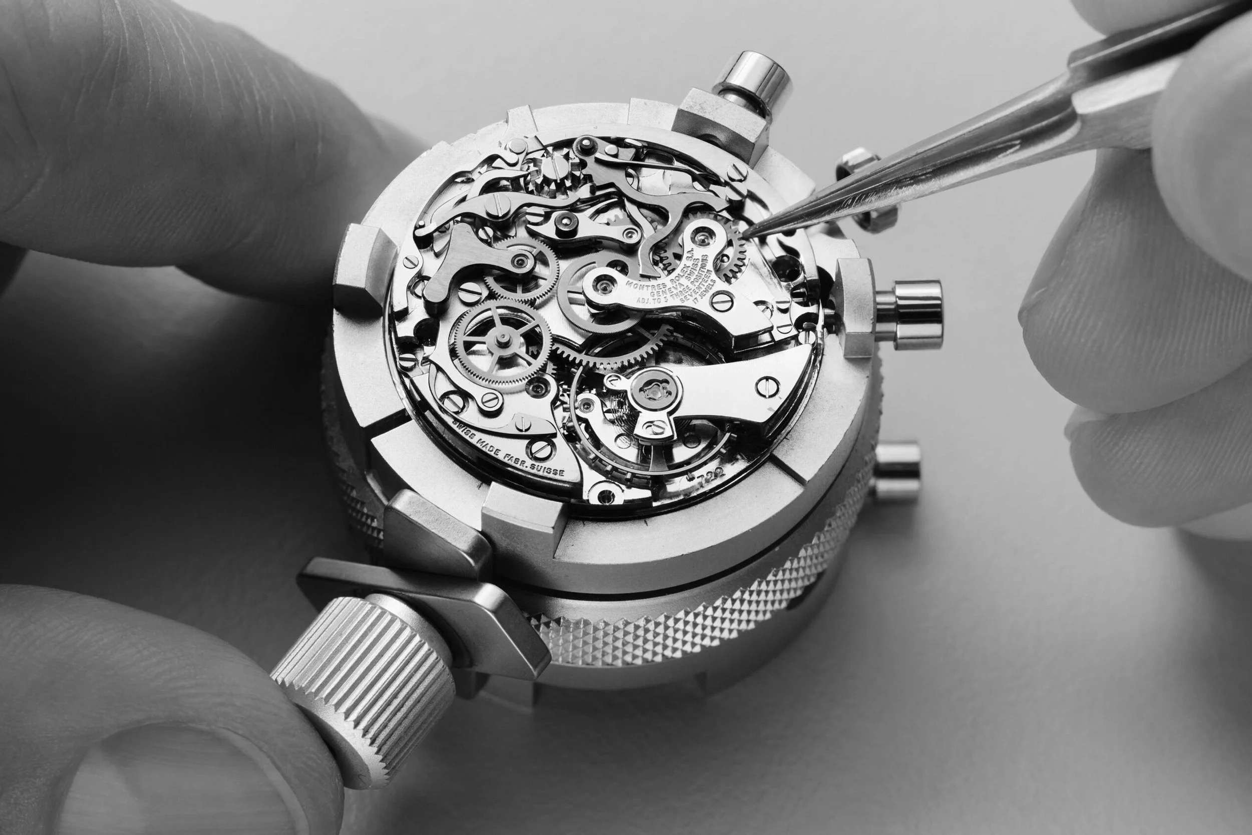 Vintage Rolex chronograph movement being serviced with tweezers in-house at Watch Repair Maastricht